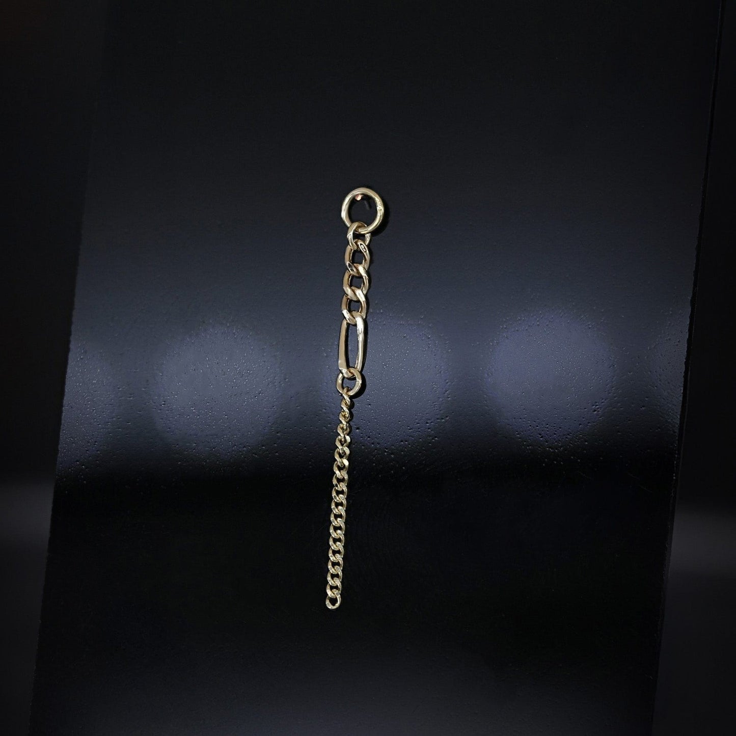 14K gold mixed-link drop chain charm on a dark background