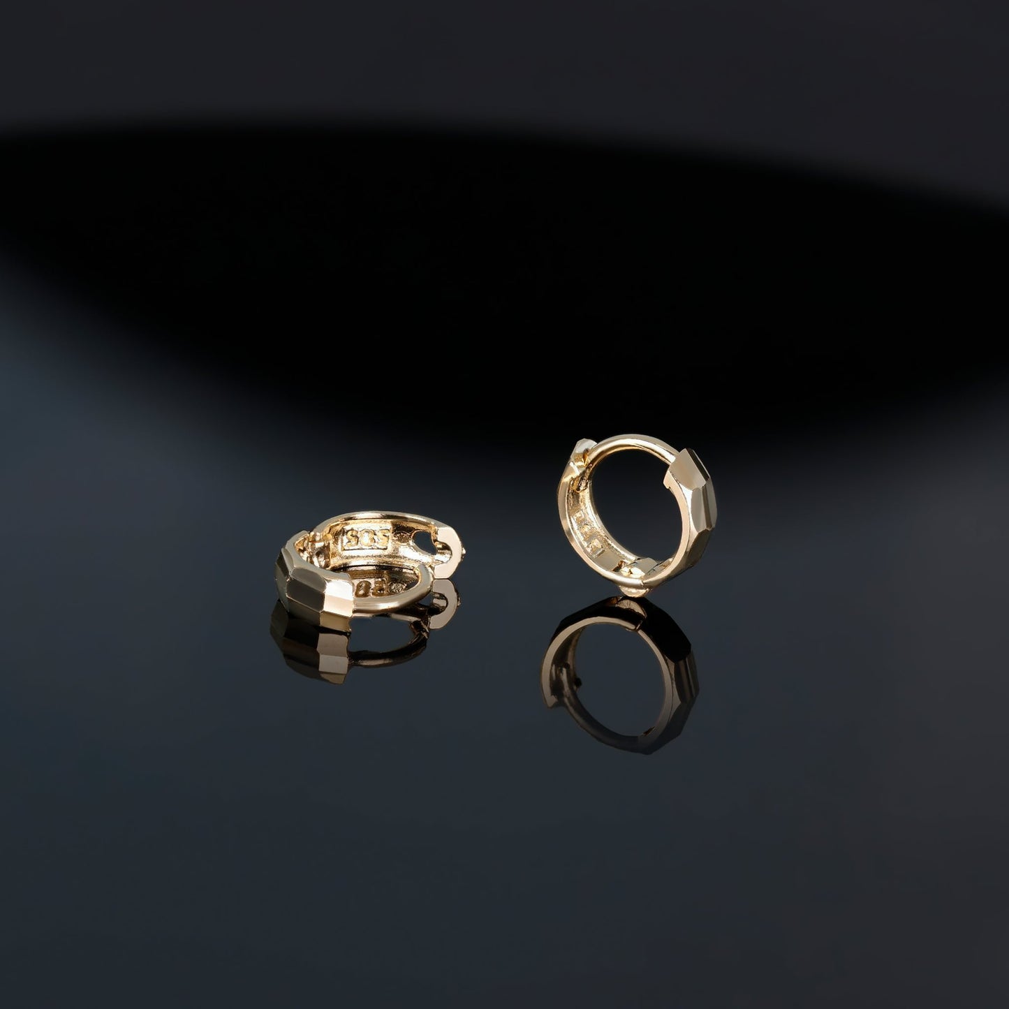 A brilliant faceted diamond-cut design Huggie Hoop