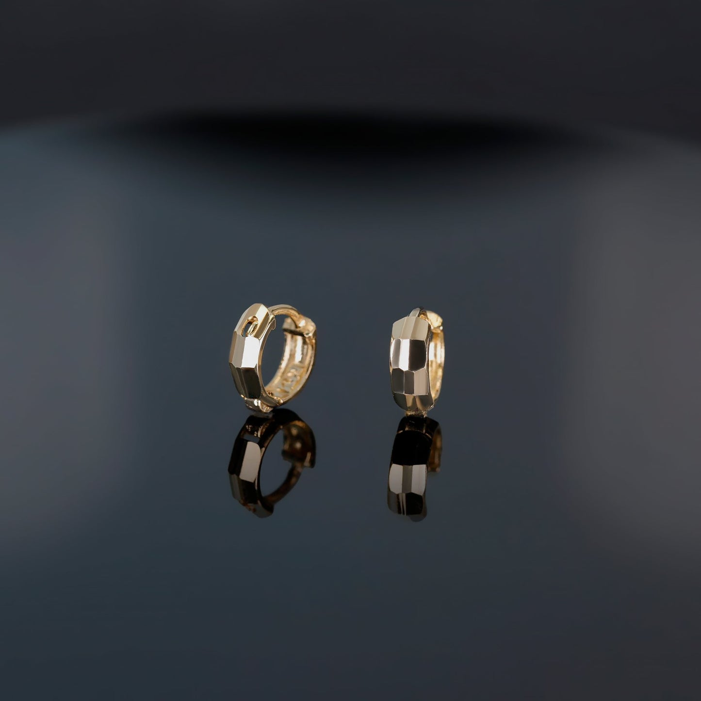 A brilliant faceted diamond-cut design Huggie Hoop