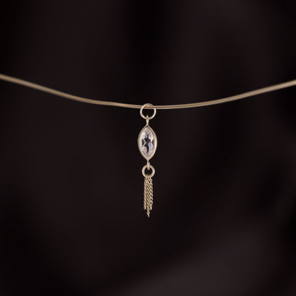 14K gold charm of a marquise-cut white topaz paired with three delicate gold curb chain tassels