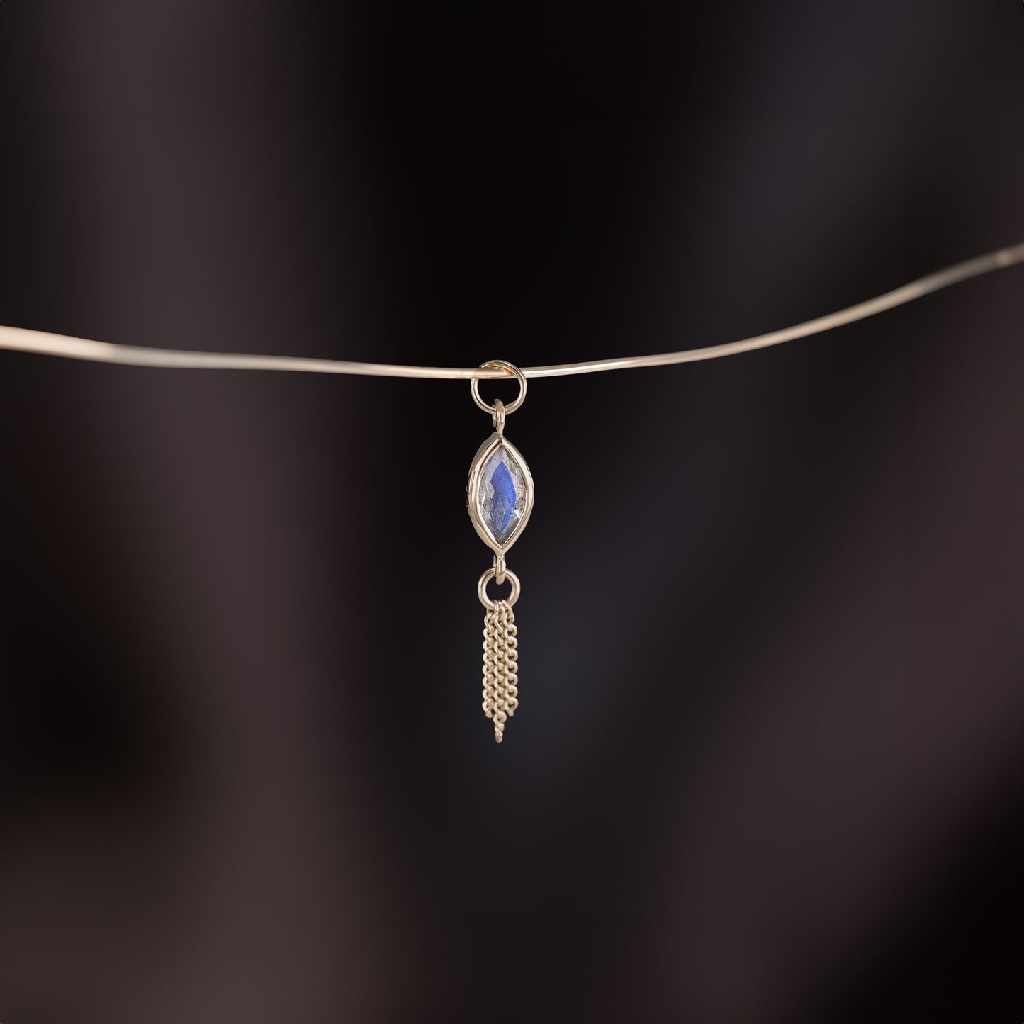 14K gold charm of a marquise-cut Labradorite paired with three delicate gold curb chain tassels