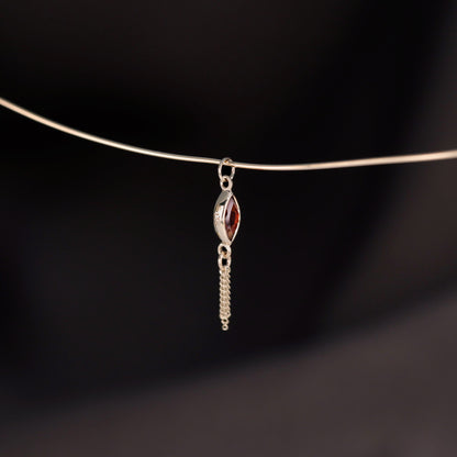 14K gold charm of a marquise-cut Garnet paired with three delicate gold curb chain tassels