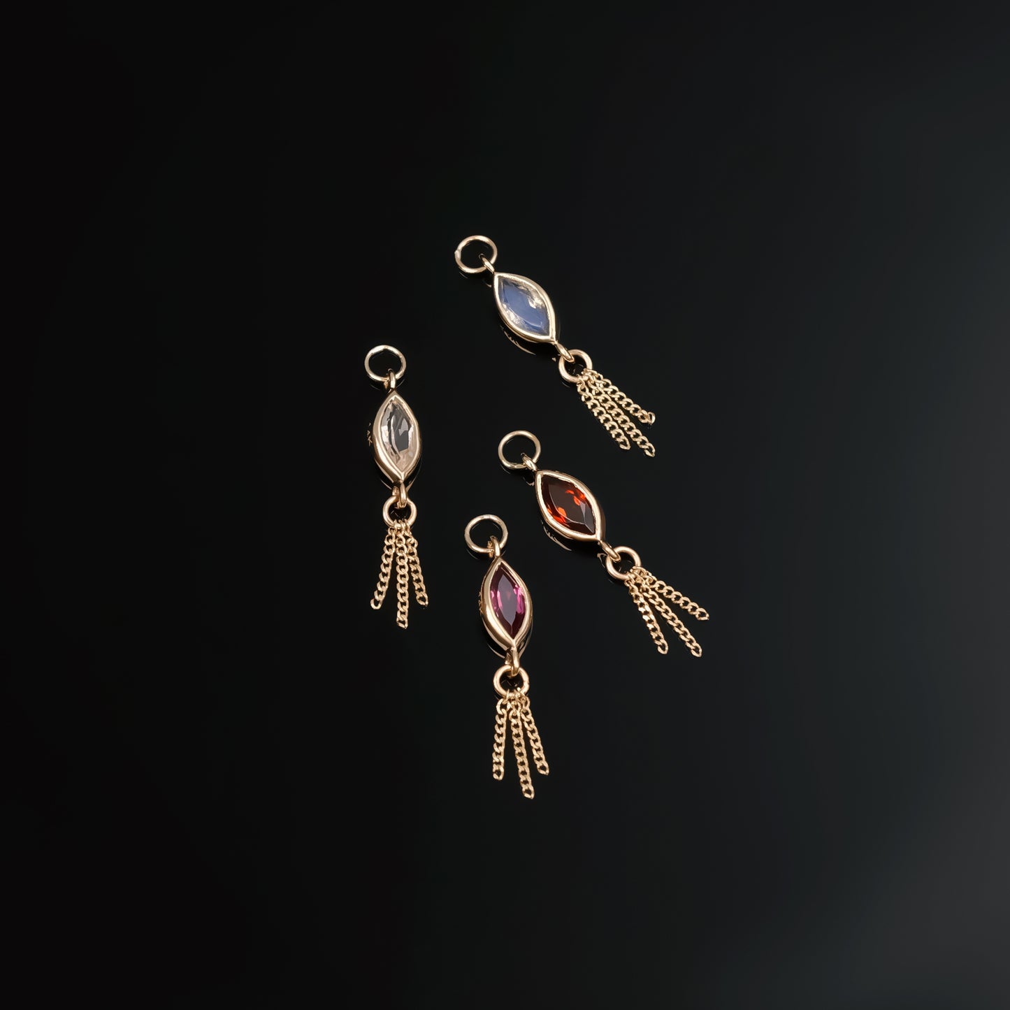 14K gold charm of a marquise-cut natural gemstones paired with three delicate gold curb chain tassels