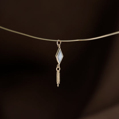 14K gold charm of a kite a Rhombus-cut Grey Moonstone paired with three delicate gold curb chain tassels