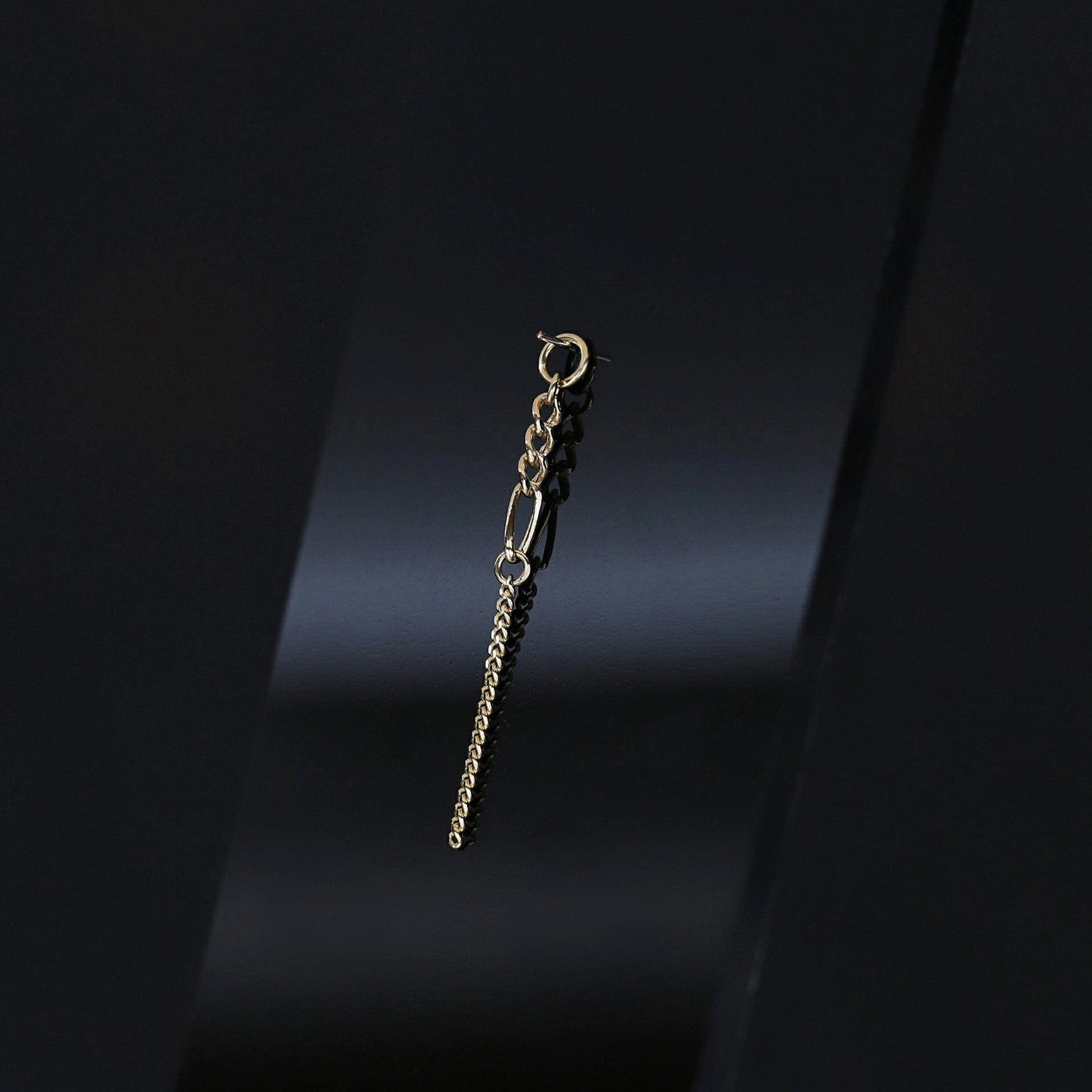 14K gold mixed-link drop chain charm on a dark background