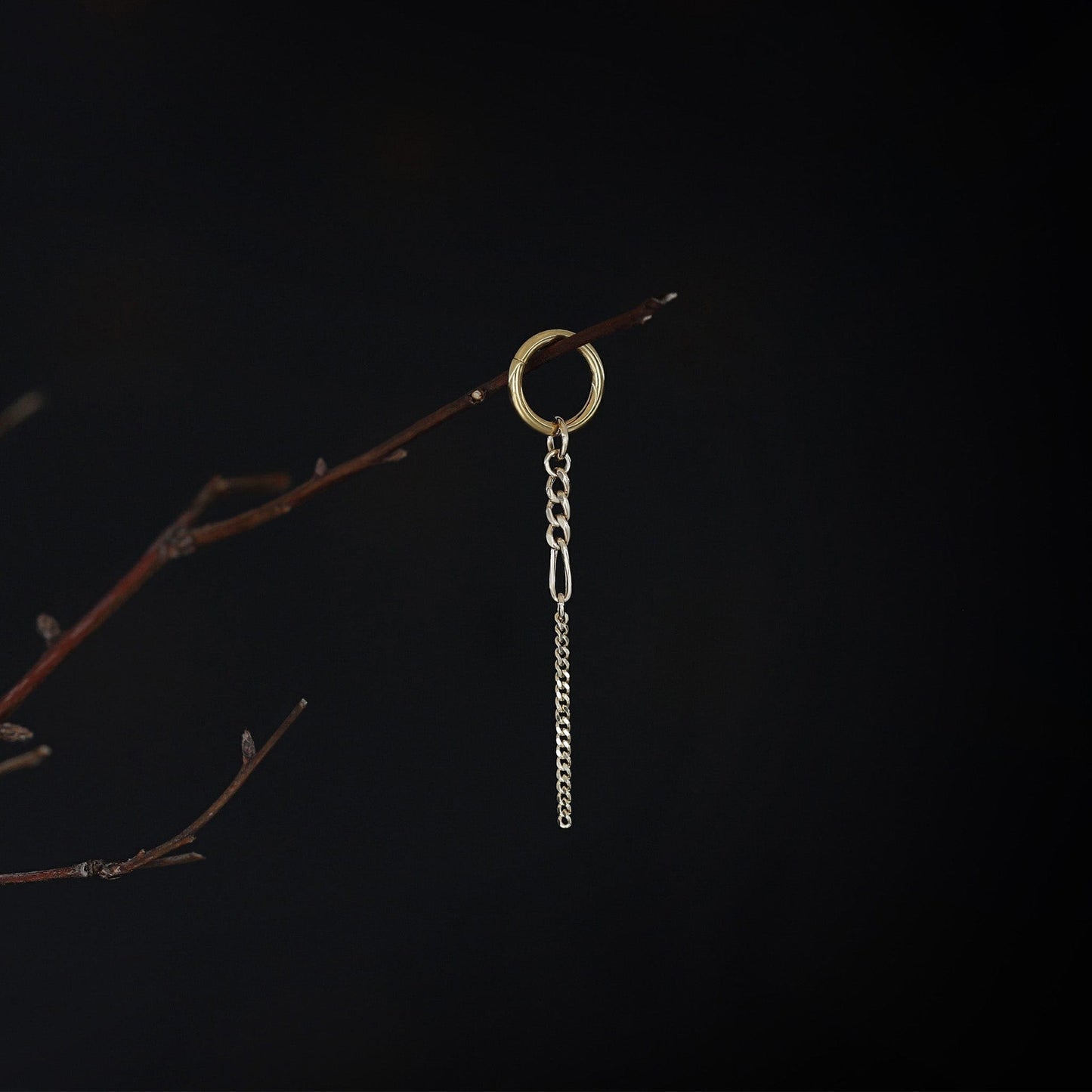 14K gold mixed-link drop chain charm hanging on a branch