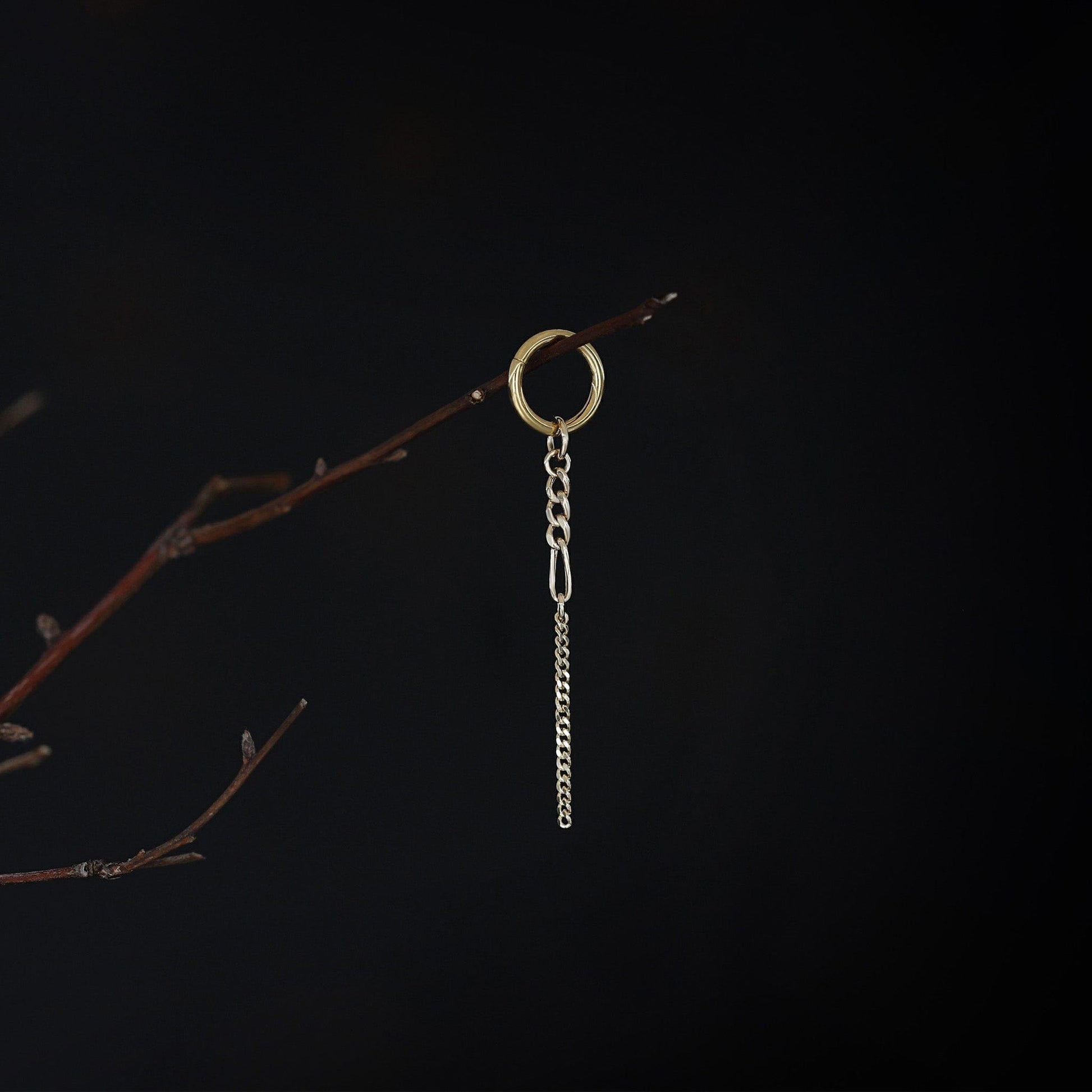 14K gold mixed-link drop chain charm hanging on a branch