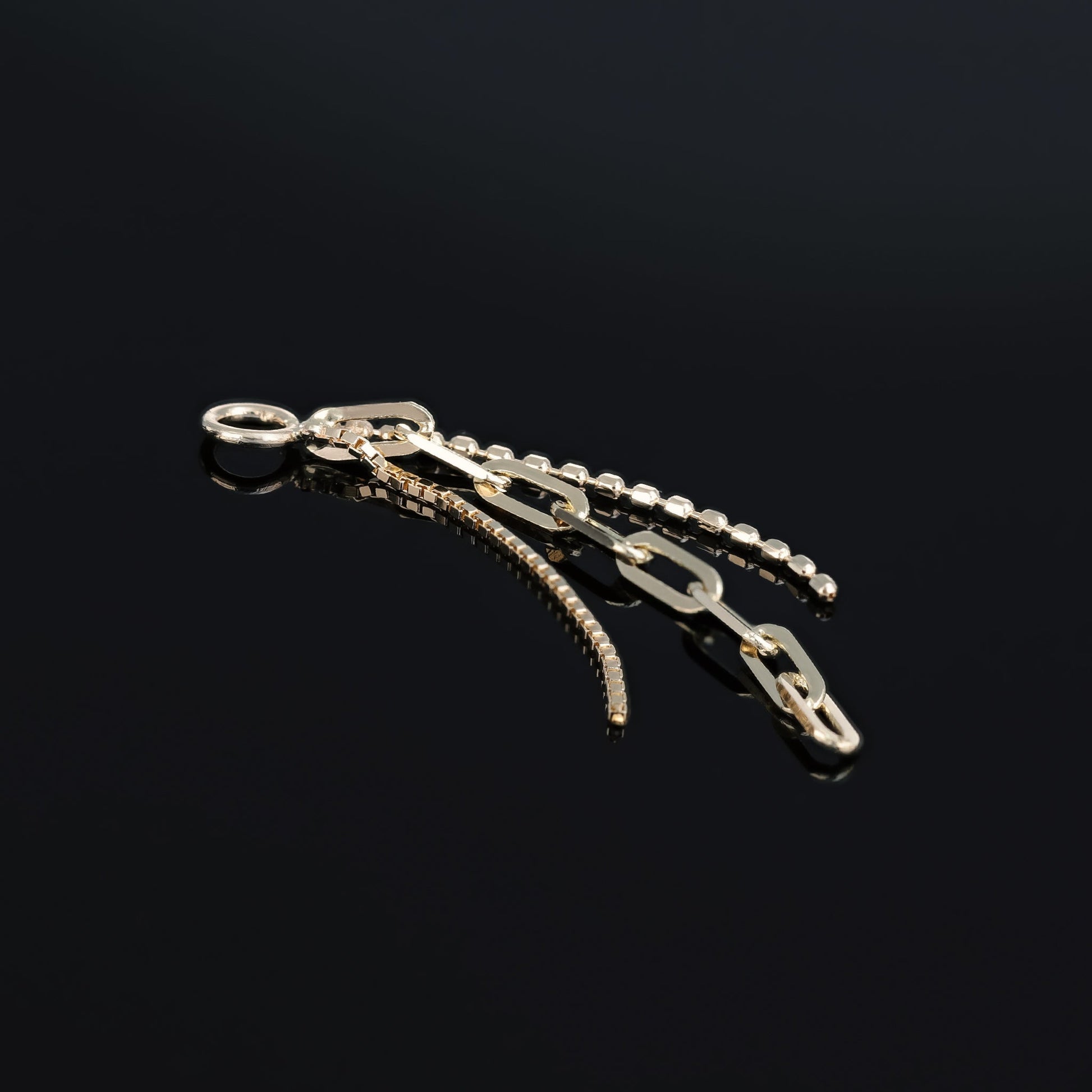 14K yellow gold mixed chain charm that comes with clip chain, box chain and ball chain displayed on black surface