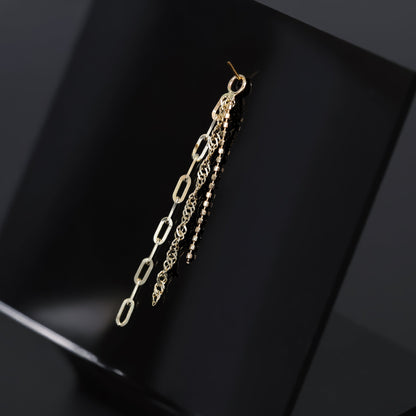 14K yellow gold mixed chain charm that comes with clip chain, box chain and Singapore chain displayed on black surface