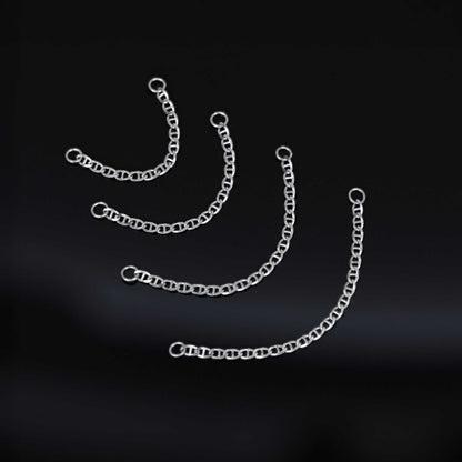 Four types of white gold chain attachments of different lengths on a black background