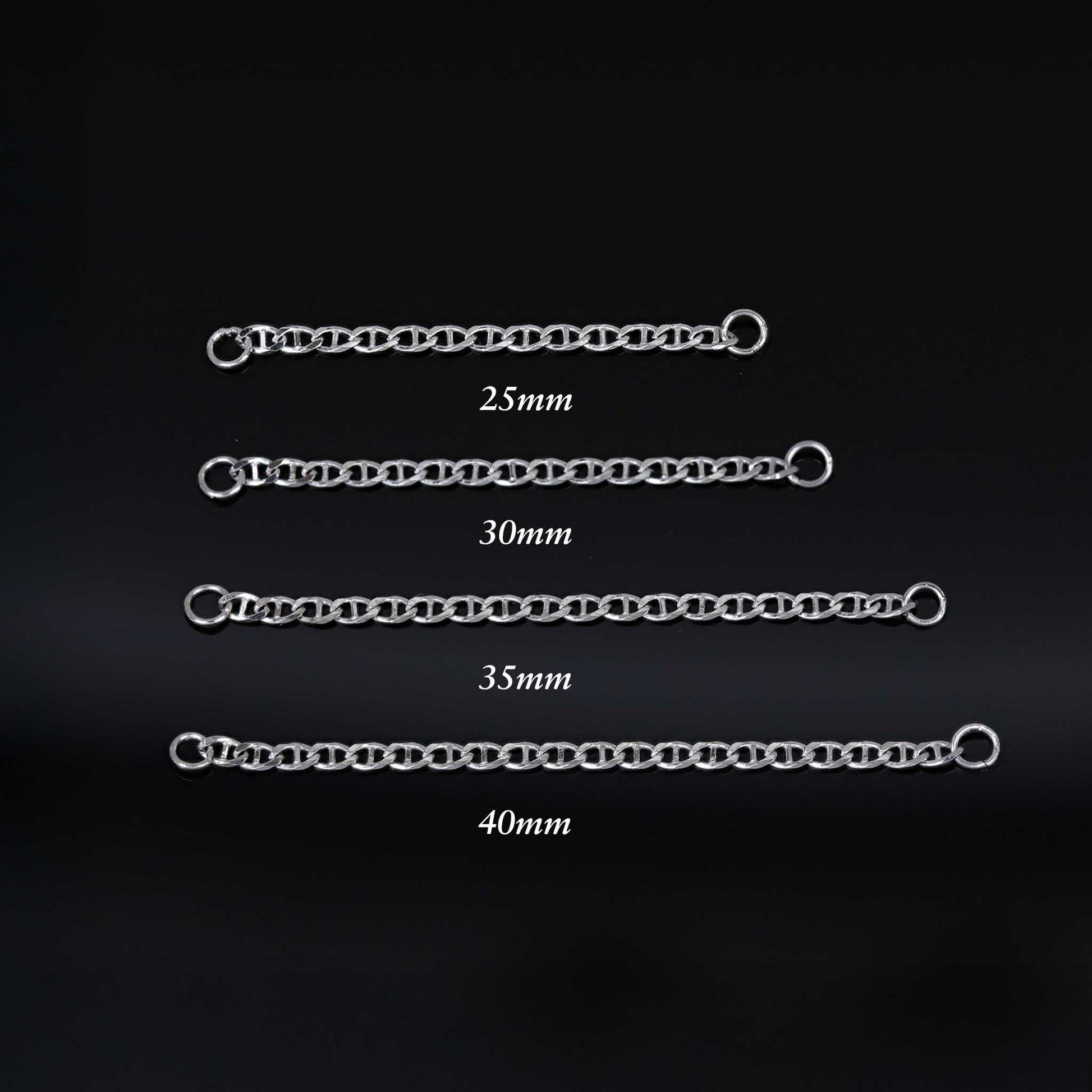 Set of four white gold chain attachments with measurements on a black background